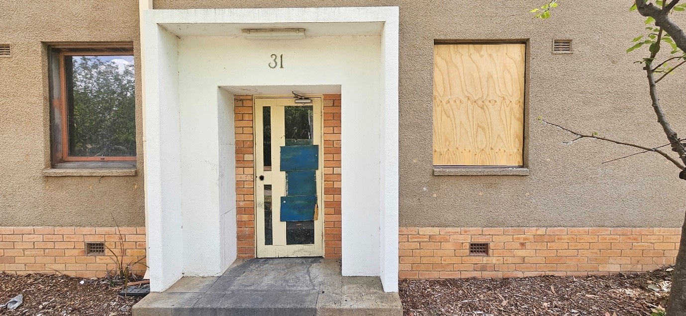 Apartment with door boarded up