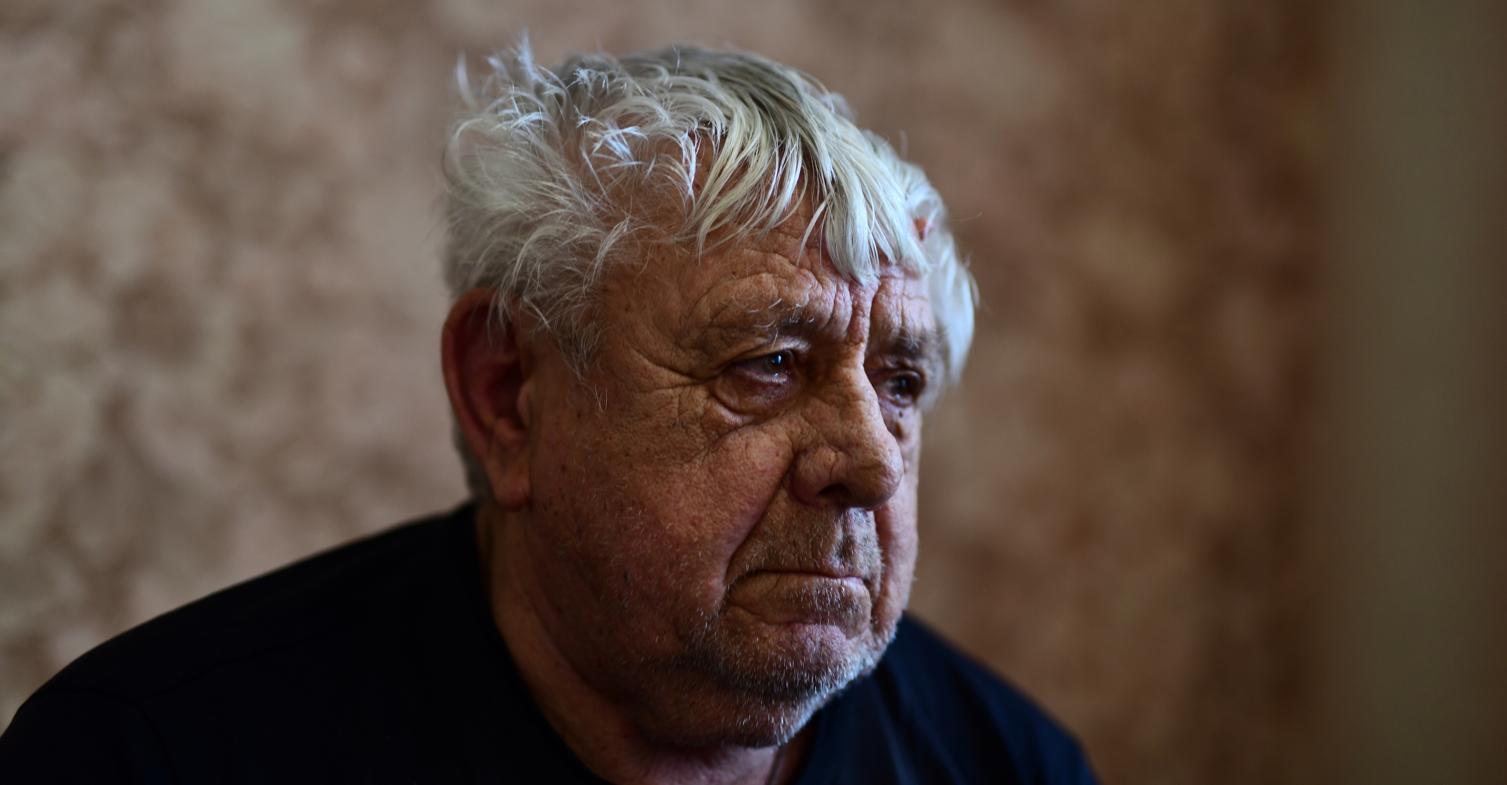 man looking out prison window