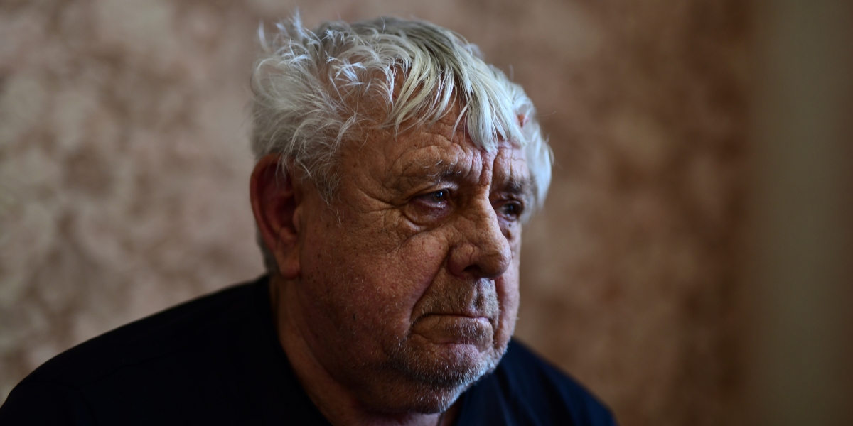man looking out prison window
