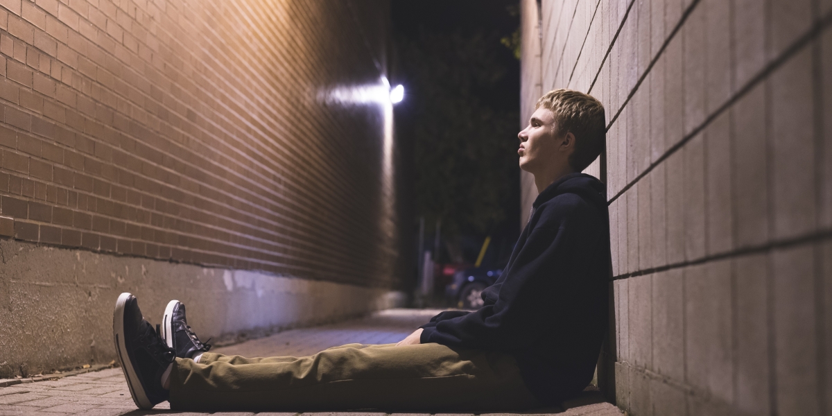 Young boy sitting on floor 